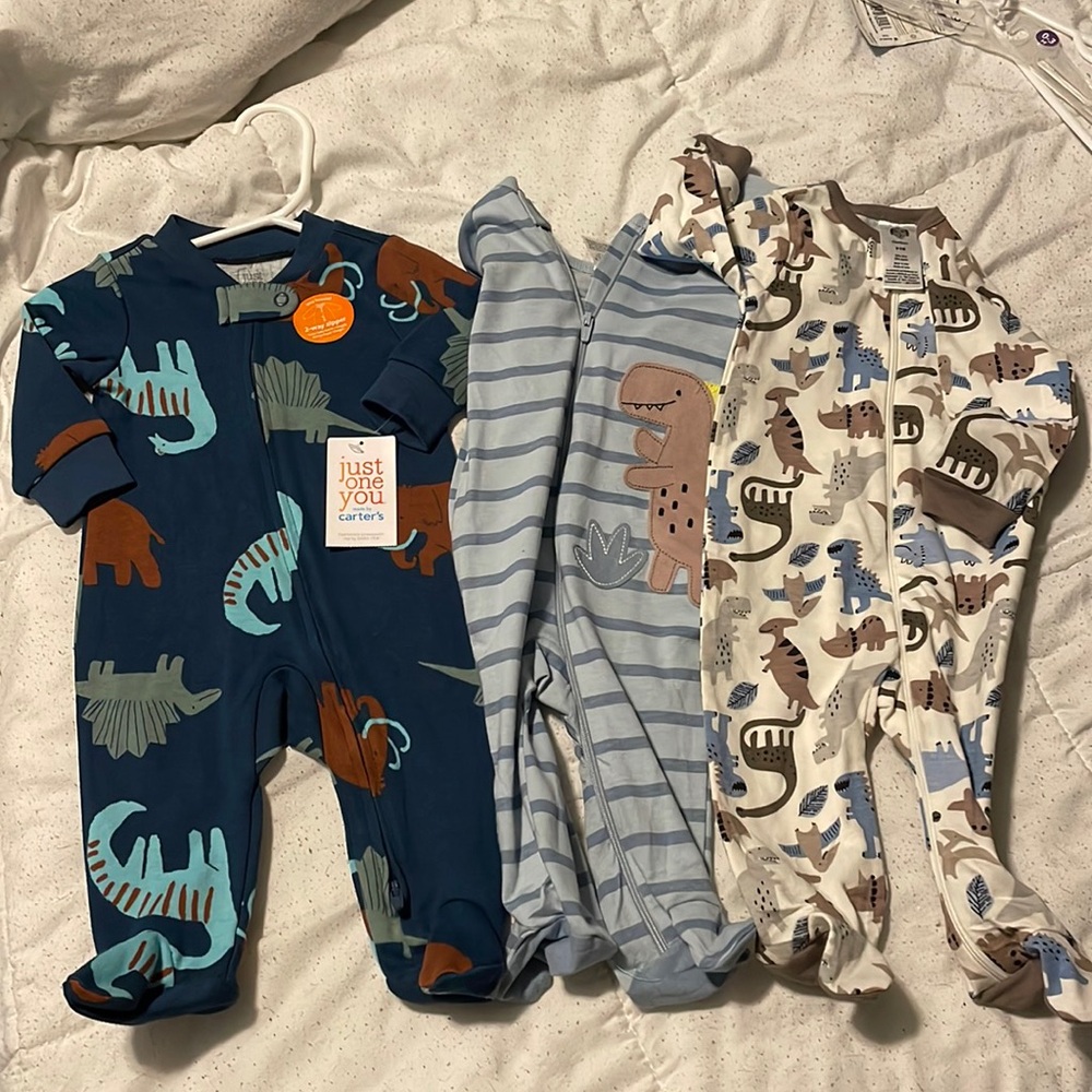 Lot of 3 sleep and play outfits. New with tags. Size 3 months. Gerber and carter